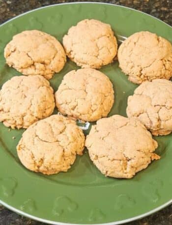 Disneyland Pumpkin Cookies Recipe: 8 cookies on a green plate with Mickey Mouse emblems around the edge.
