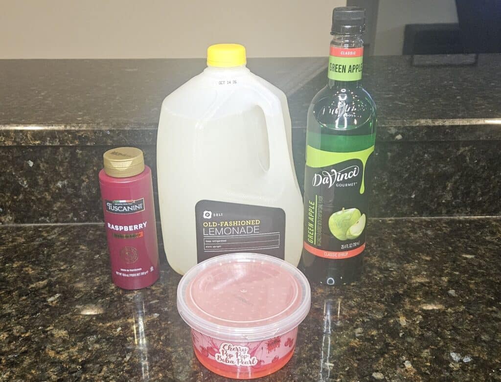 Green Apple Spell Lemonade Ingredients: Raspberry Sauce, Lemonade, Green Apple Syrup, Cherry Popping Boba